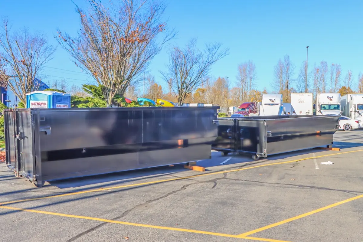 Professional dumpster rental service with roll-off container on residential driveway in Ashwaubenon